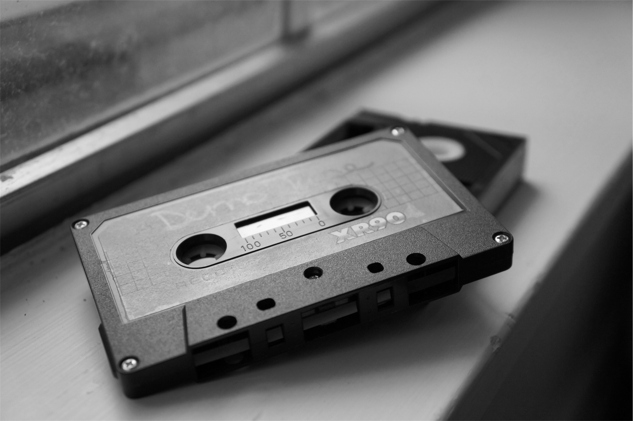 cassette tape wallpaper,compact cassette,monochrome,metal,musical instrument accessory