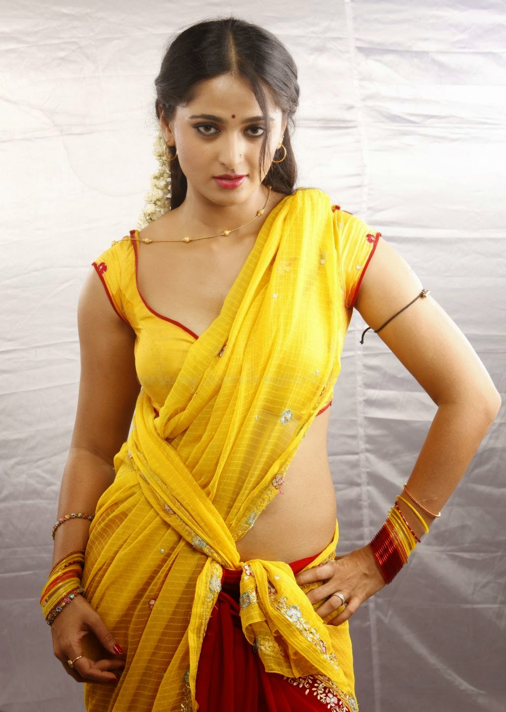 anushka shetty hd saree wallpapers,clothing,yellow,fashion model,abdomen,photo shoot