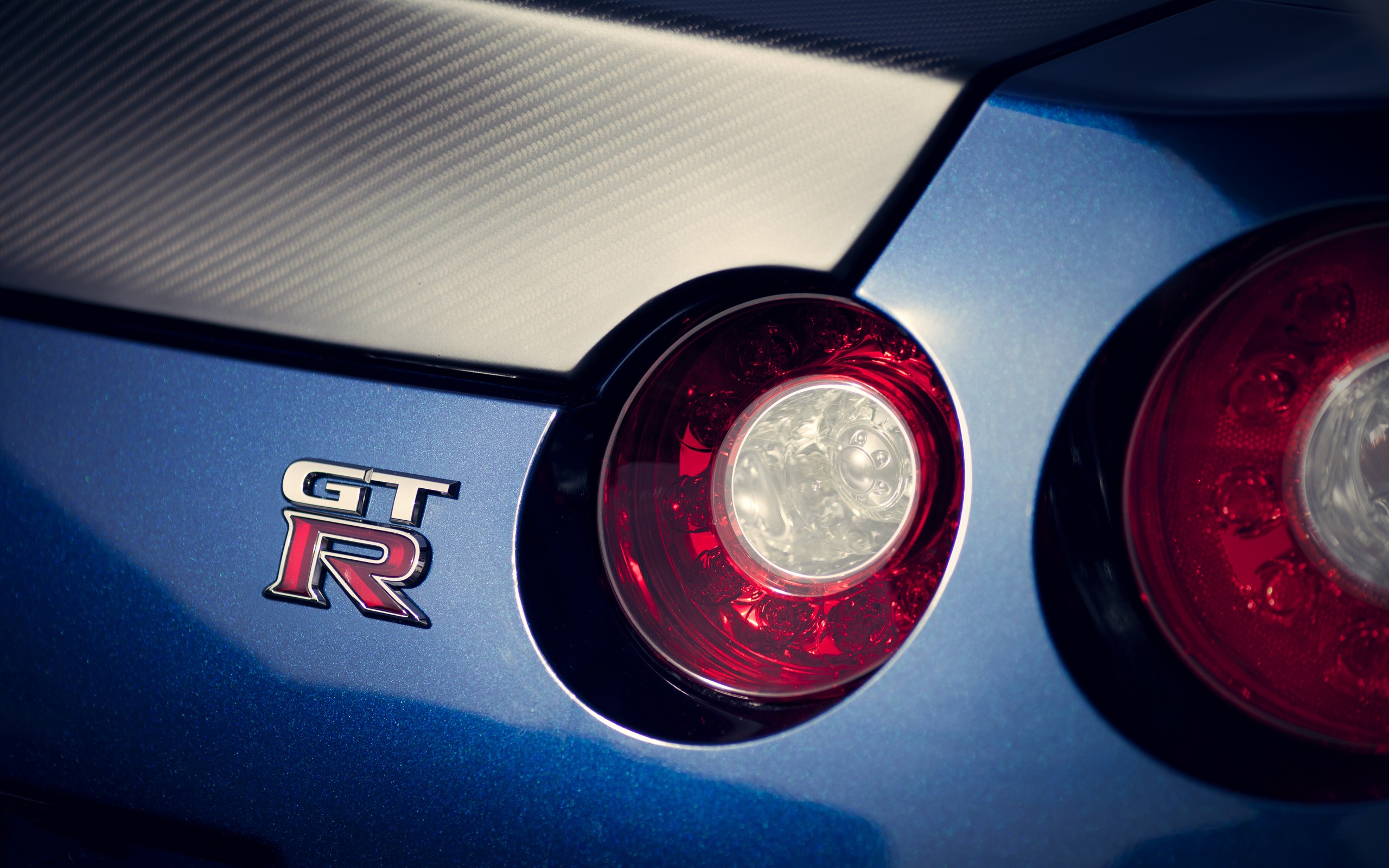 gtr logo wallpaper,land vehicle,vehicle,car,automotive lighting,nissan gt r