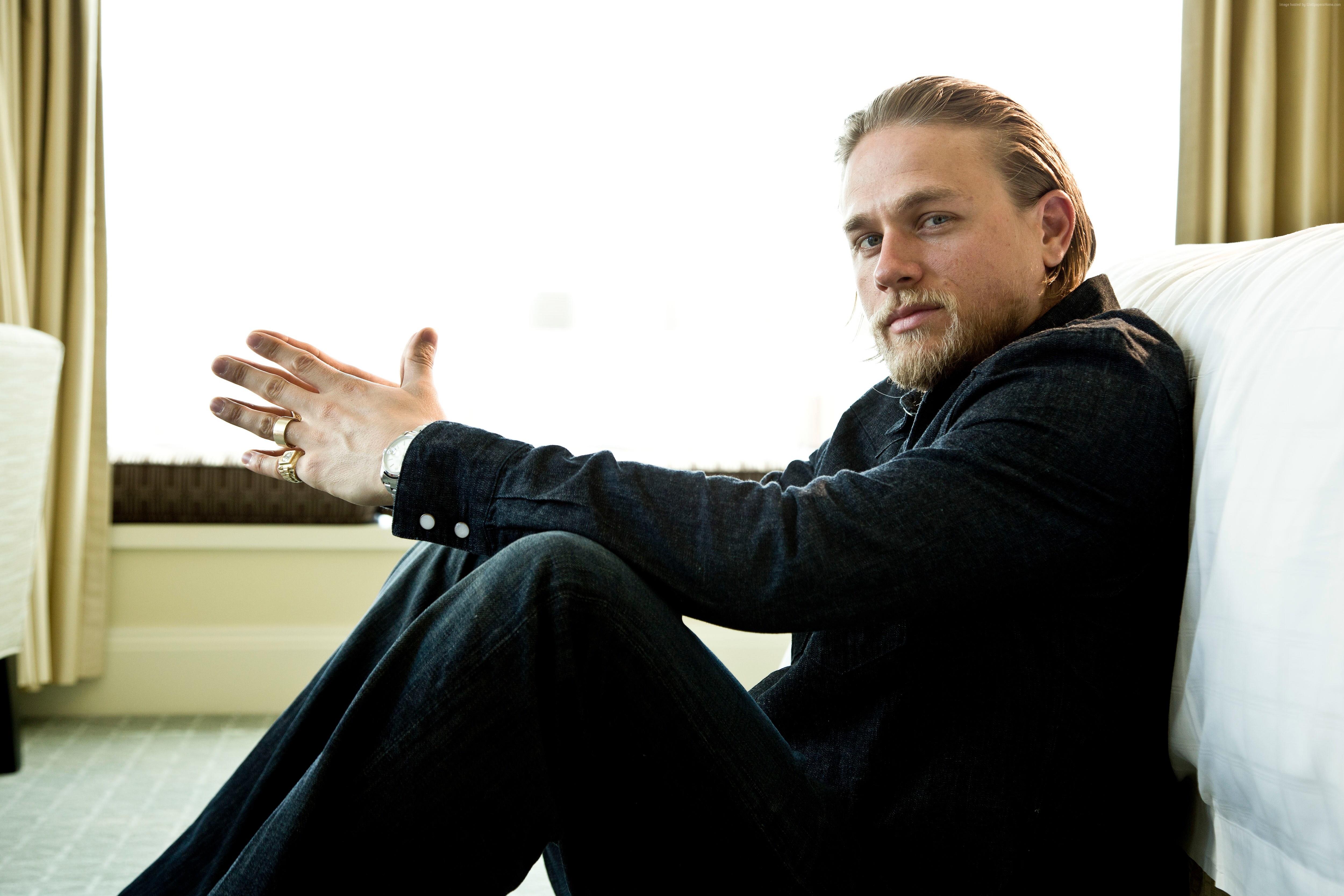 charlie hunnam wallpaper,sitting,technology,hand,gesture,photography