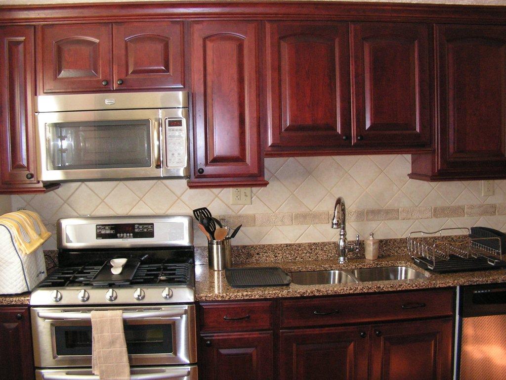 kitchen wallpaper that looks like tile,countertop,cabinetry,kitchen,furniture,room