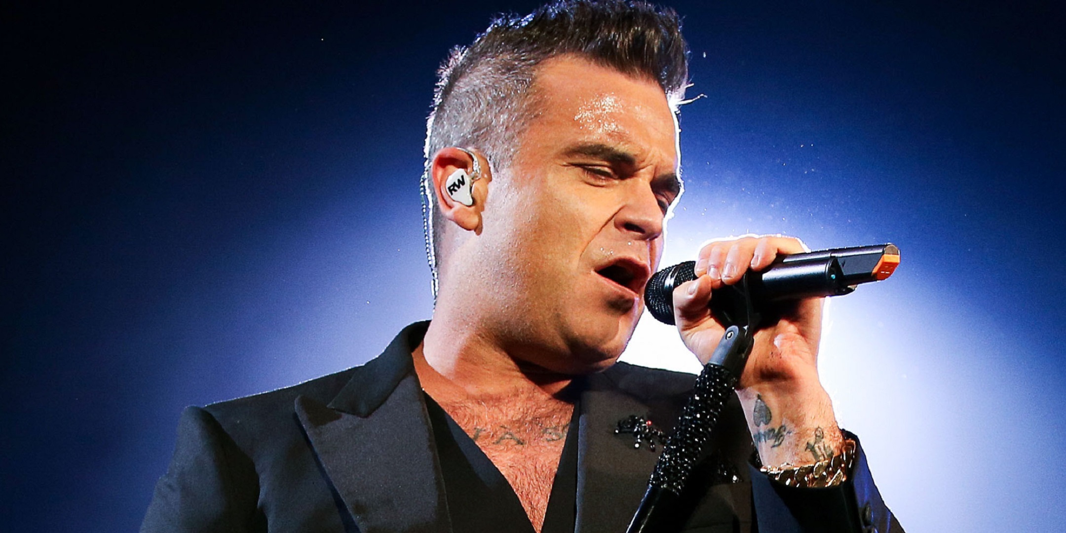 sfondo di robbie williams,cantante,cantando,divertimento,musica,prestazione