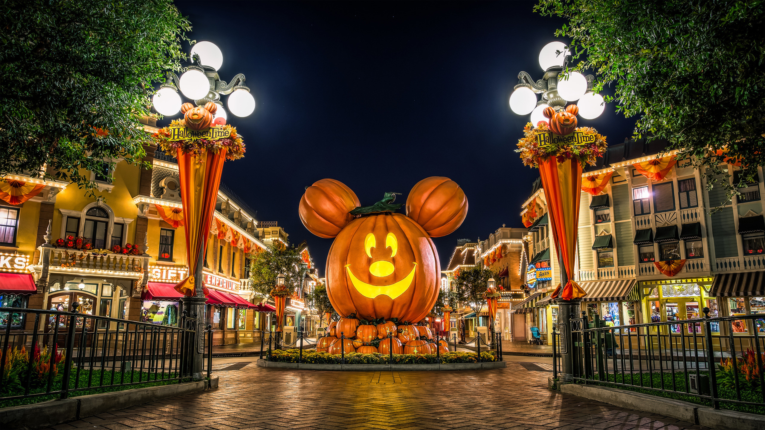 disney halloween wallpaper,night,town,amusement park,lighting,sky