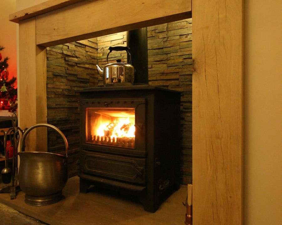 wallpaper around fireplace,heat,hearth,wood burning stove,fireplace,wood